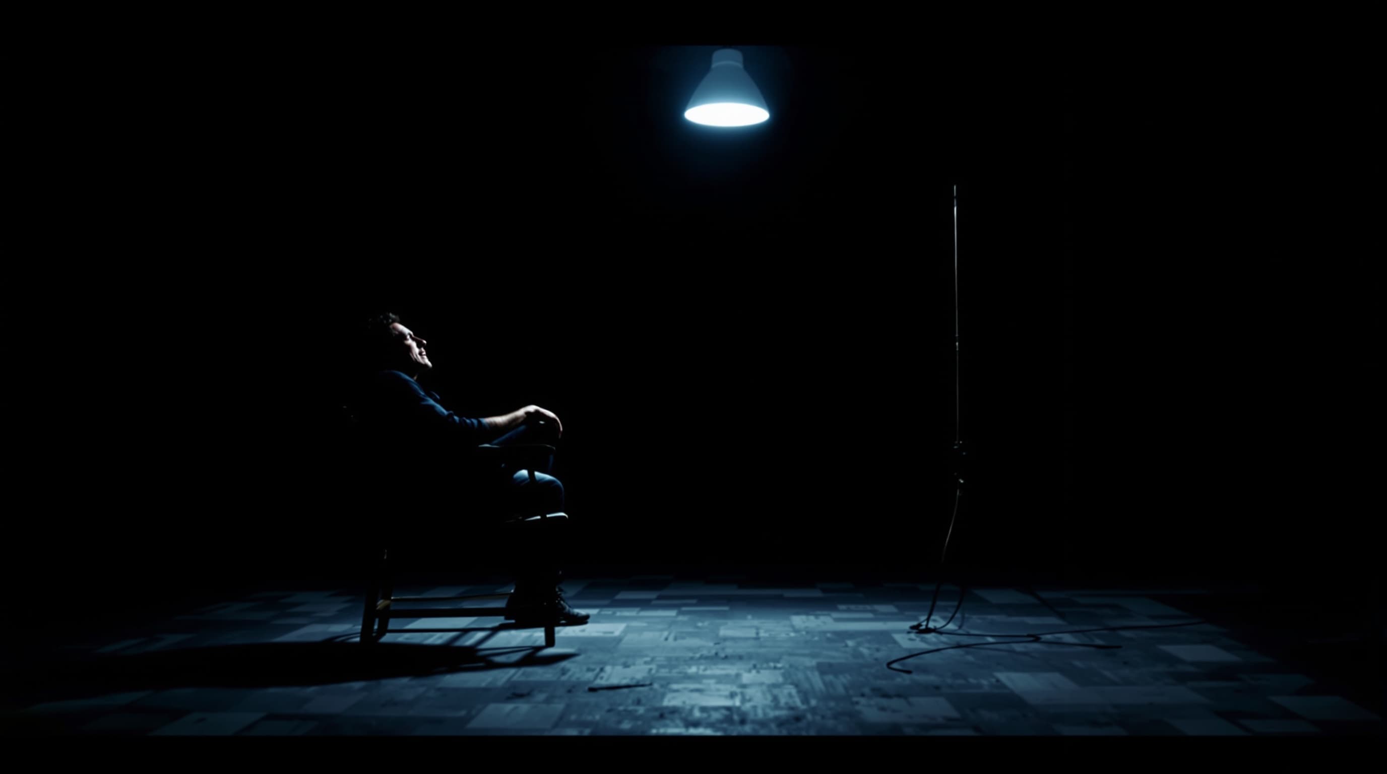man sitting alone in a dark room with a single light source, shadows, emotional breakdown, minimal scene, cinematic, high contrast